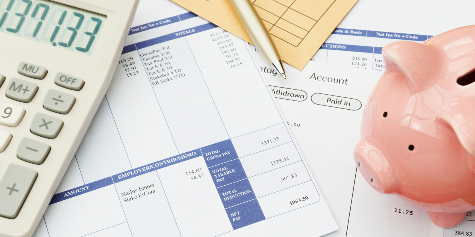 Variety Of Financial Objects Arranged On Wage Slip