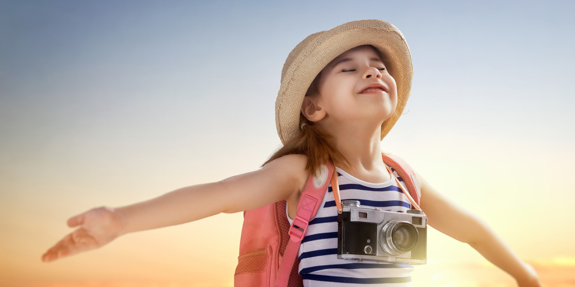 Little girl traveler smiling with arms wide out