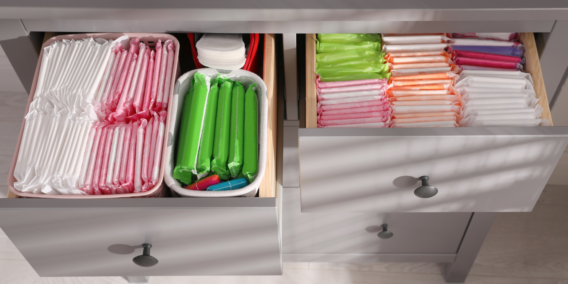 Open drawers with rows of menstrual products in bright colors