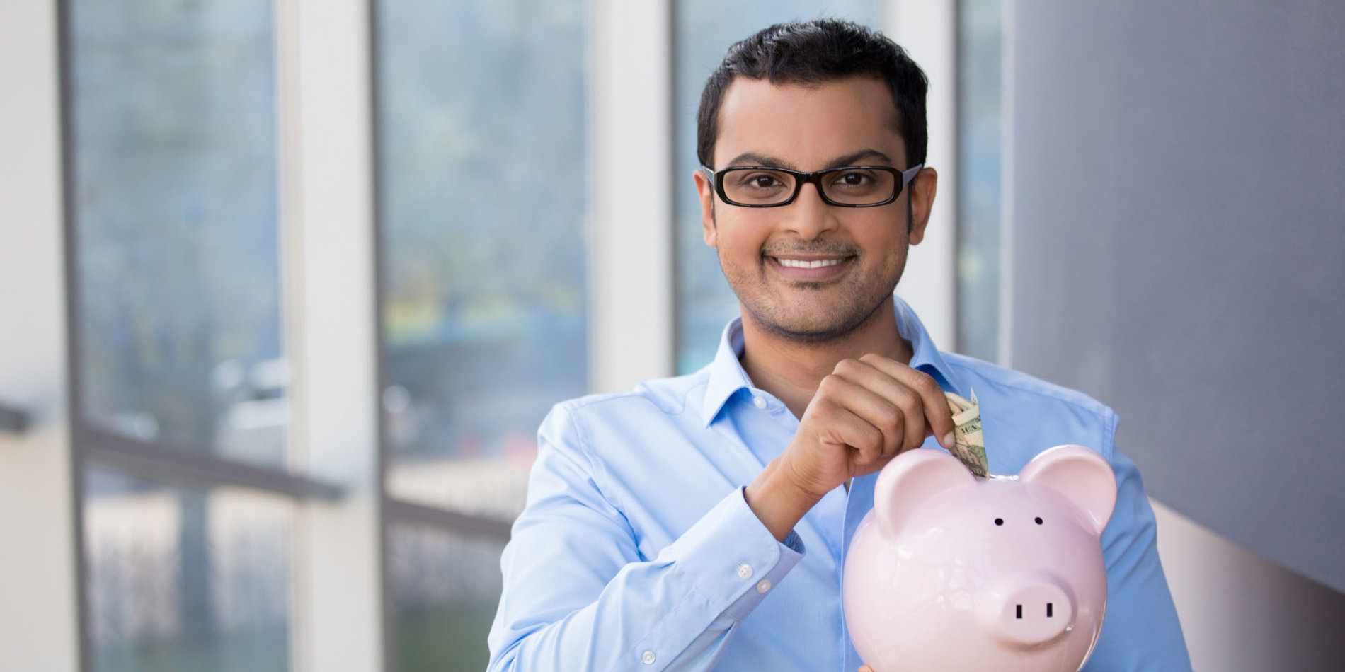 Young man holding piggy bank