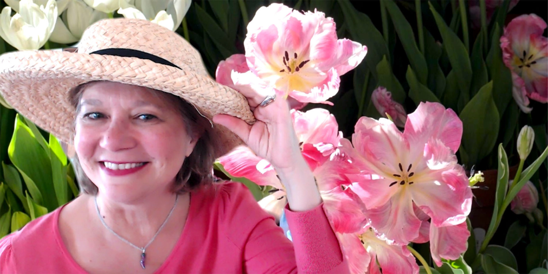 Rossella Derickson posing with her hat in front of a virtual background of tulips at the Filoli gardens