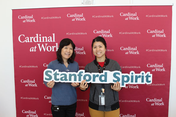 Stanford employees holding Stanford spirit sign