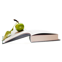 Green apple on top of a open book