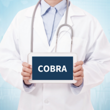 Doctor holding a table with a COBRA sign on blue background