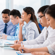 Woman with coworkers paying attention to a meeting
