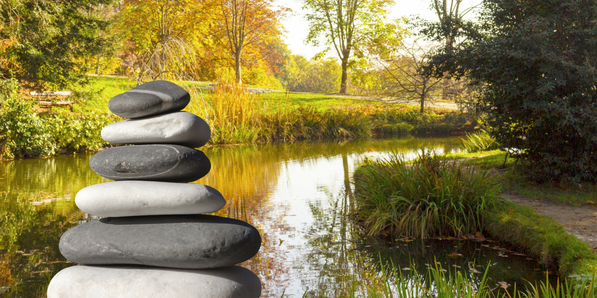Close up of zen stones with background the garden and the lake
